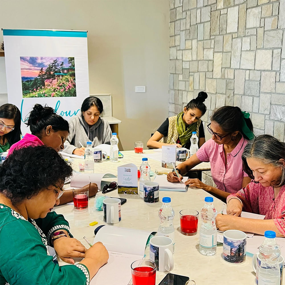 Furniture,Arm,T-shirt,Table,Shirt,Chair,Interaction,Sharing,Drinkware,Desk