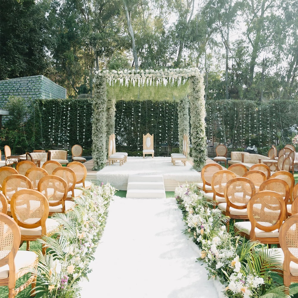 Garden,Flower Arranging,Floristry,Ceremony,Floral design,Botanical garden,Aisle,Decoration,Outdoor Structure,Wedding reception