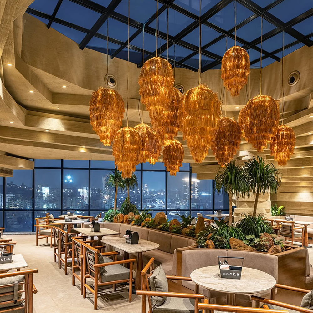 Interior design,Ceiling,Light fixture,Chandelier,Lighting,Lobby,Restaurant,Lampshade,Natural material,Chair